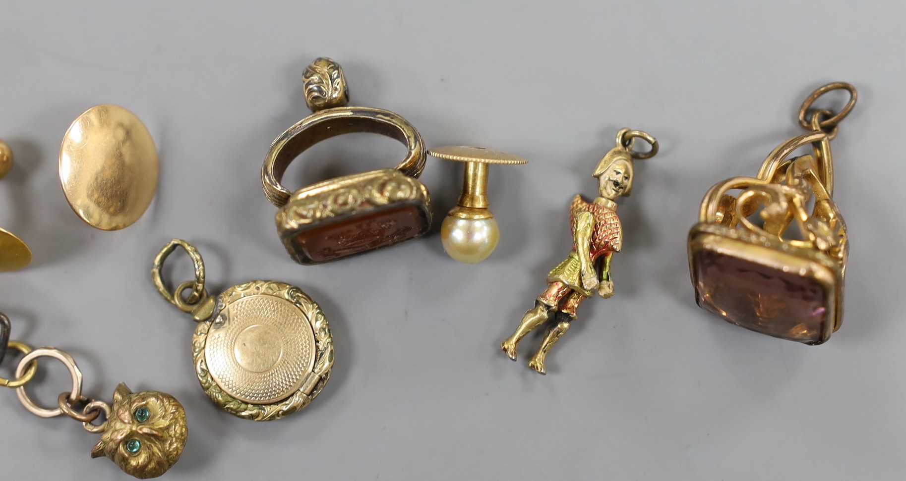 Mixed small jewellery including three yellow metal dress studs, an Egyptian 'mummy' charm, two 19th century gilt metal and semi-precious gem set fob seals and two other items including a gilt metal locket.